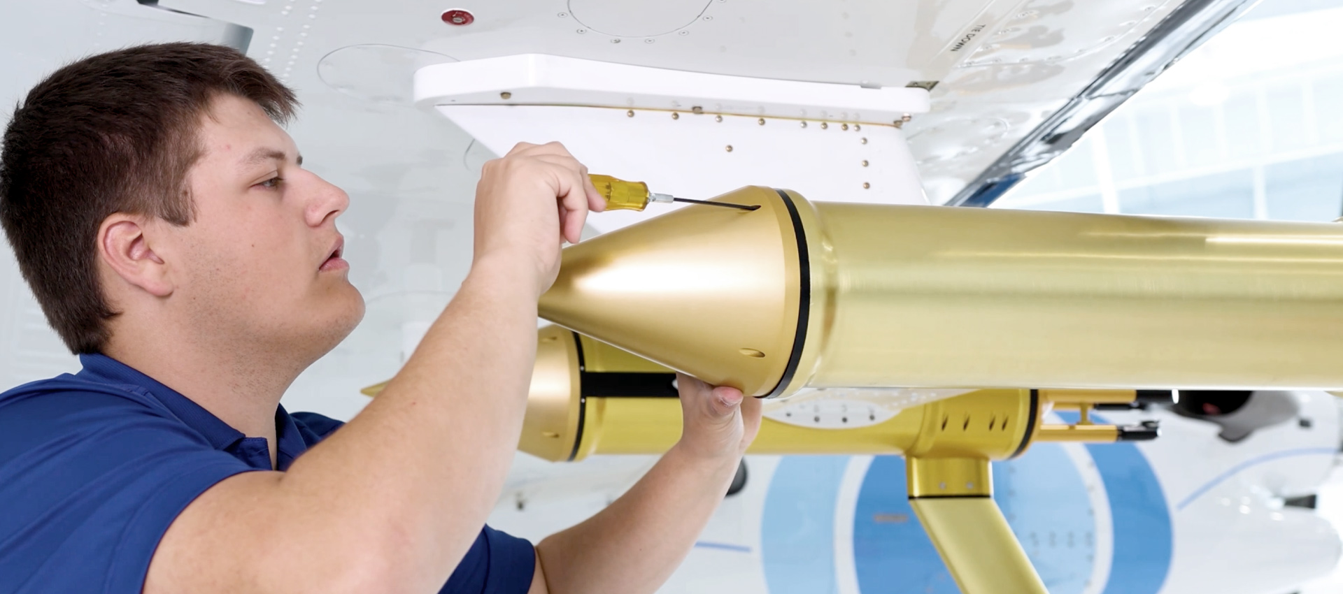 A SPEC technician installs aircraft research instrumentation on a wing
