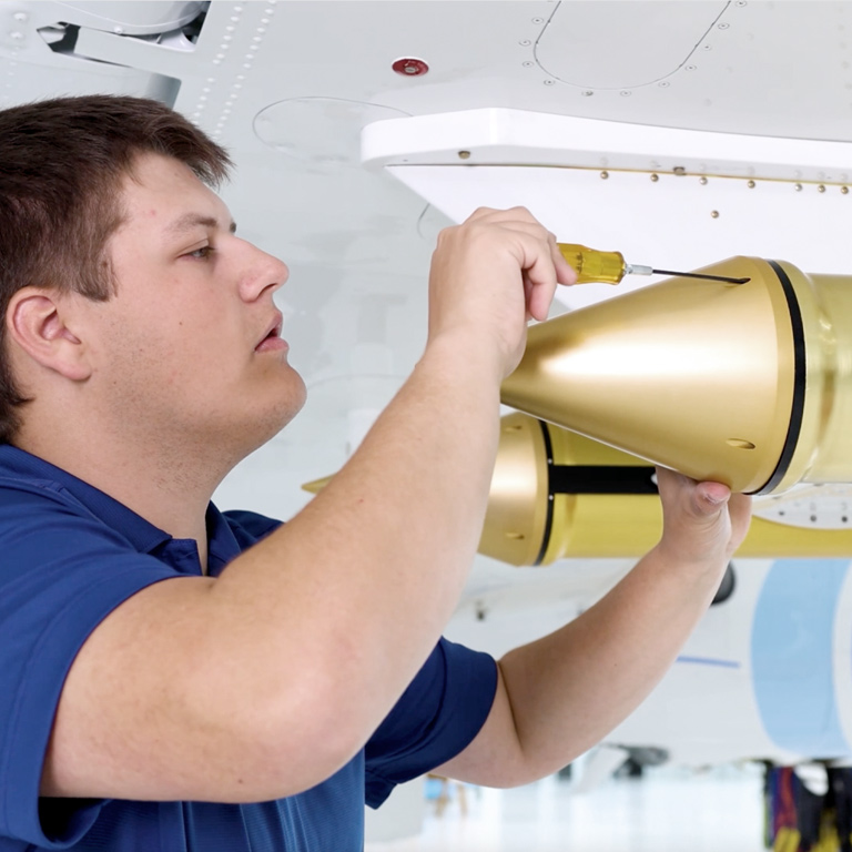 SPEC technician installing aircraft research instrumentation on a wing