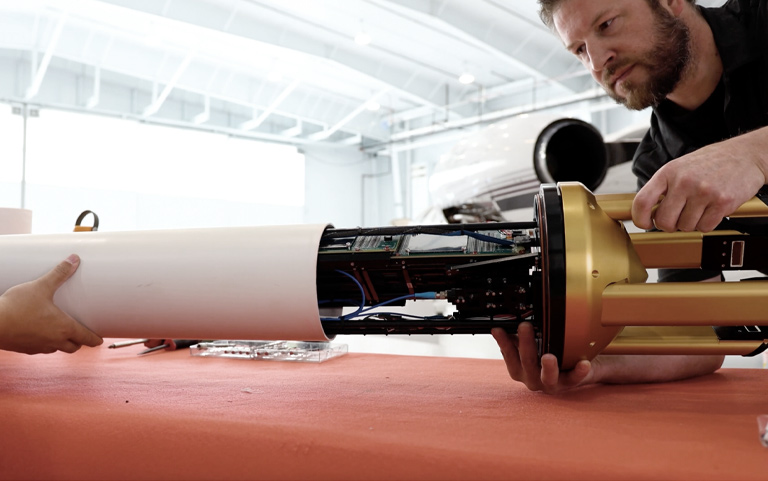 A SPEC technician recalibrates and services a research instrument